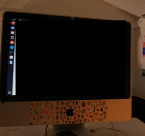 old desktop computer running Ubuntu, covered in stickers